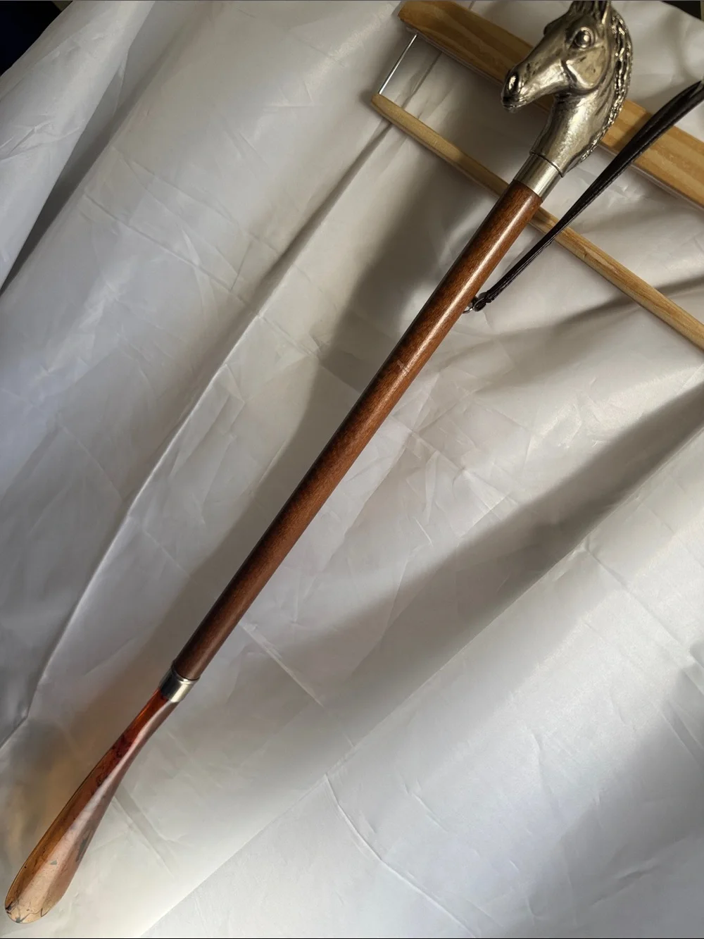 Decorative shoe horn made in Italy. Horse head/metal, wooden shaft, plastic.